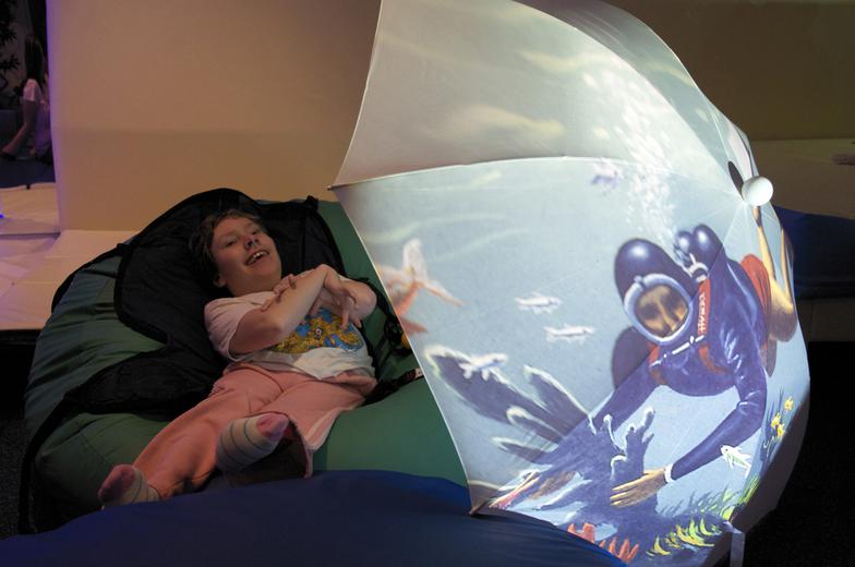 child smiling under broiley with projected scuba diver