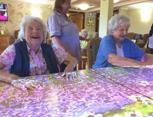women with dementia playing on omi