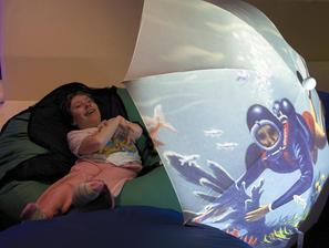 Girl enjoying scuba diver projected on brolley