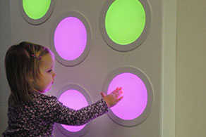 girl playing with wall touch sound light panel